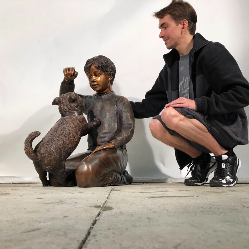 SRB42772 Bronze Boy sitting with Dog Sculpture Metropolitan Galleries Inc.