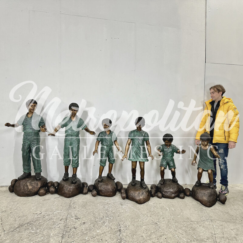 SRB48814 Bronze Six Children Walking Across Stones Sculpture Set by Metropolitan Galleries Inc SCALE WM