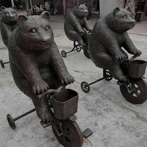 SRB10129 Bronze Bear riding Tricycle Sculpture exclusively designed and produced by Metropolitan Galleries Inc